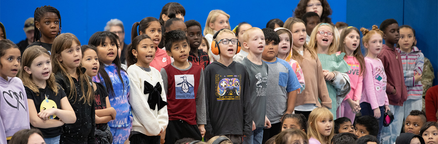 students standing at assembly